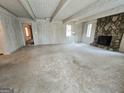 Large living room with stone fireplace and access to other rooms in the house at 2996 Jodeco Dr, Jonesboro, GA 30236