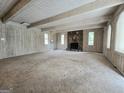 Bright and airy living room with stone fireplace and wood-paneled walls at 2996 Jodeco Dr, Jonesboro, GA 30236