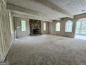 Spacious living room featuring a stone fireplace and light-colored wood panels at 2996 Jodeco Dr, Jonesboro, GA 30236