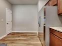Bright kitchen featuring wood floors, stainless steel refrigerator, and granite countertops at 3741 Upland Dr, Mcdonough, GA 30253