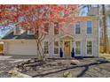 Charming two-story home featuring a brick facade, attached garage, and mature landscaping at 104 Pine Pt, Peachtree City, GA 30269