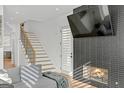 Stylish living room features a modern fireplace, a comfortable sofa, and a staircase at 265 High St, Fayetteville, GA 30214