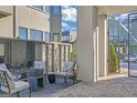 Inviting patio area with cushioned chairs, accent table, and view to the community walkway at 265 High St, Fayetteville, GA 30214