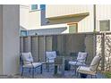 Cozy outdoor patio with comfortable seating around a small table and a decorative black panel at 265 High St, Fayetteville, GA 30214