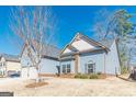 Traditional home exterior boasts a spacious two-car garage and manicured lawn at 4050 Villagewood Ln, Ellenwood, GA 30294