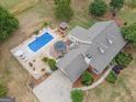 Aerial view showcasing a home with an in-ground pool, gazebo, and manicured landscaping at 245 Jewel Blf, Fayetteville, GA 30214