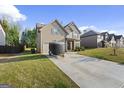 Two-story home with a well-manicured front lawn and a paved driveway with a trailer at 6870 Diamond Dr, Rex, GA 30273