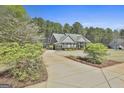 Spacious home with lush landscaping and a long driveway leading to the house at 410 Denton Cir, Fayetteville, GA 30215