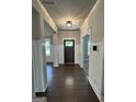 Elegant foyer with dark hardwood flooring, white wainscoting, and a stylish light fixture at 2470 Wevok Way, Grayson, GA 30017