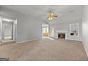 Spacious living room features a fireplace and a ceiling fan at 140 Jodeco Station Ter, Stockbridge, GA 30281