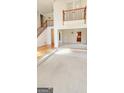 Bright living room with carpeted floors, grand staircase and views to dining area at 3626 Lone Indian Trl, Marietta, GA 30066