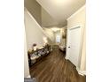 Welcoming foyer with wood floors, console table, and staircase at 2275 Church St, Hampton, GA 30228