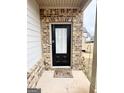 Inviting front door with brick surround and welcome mat at 2275 Church St, Hampton, GA 30228