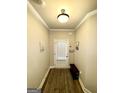 Neutral hallway with crown molding, coat rack, and warm lighting at 2275 Church St, Hampton, GA 30228