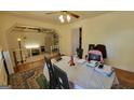 A dining room featuring hardwood floors, a ceiling fan, and an opening to an adjacent living space at 617 Virginia Cir, Forest Park, GA 30297