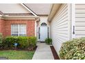 Inviting front entrance with a white door, manicured bushes, and well kept lawn at 116 Evenview Dr., Jonesboro, GA 30236