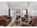 Spacious living area featuring a fireplace and plush seating arrangement on patterned rug at 116 Evenview Dr., Jonesboro, GA 30236