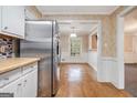 Open dining area with hardwood floors, stainless steel refrigerator, and ample natural light at 4230 Iris Brooke Ln, Snellville, GA 30039