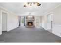 Bright living room featuring a stone fireplace, carpeted floors, and natural light at 4230 Iris Brooke Ln, Snellville, GA 30039