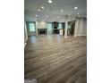 Finished basement boasts stylish vinyl floors, fireplace, a kitchen, and lots of natural lighting at 281 New Hope Dr, Mcdonough, GA 30252