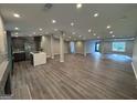 A modern finished basement is showcasing gray walls, wood floors, kitchen, and lots of recessed lighting at 281 New Hope Dr, Mcdonough, GA 30252