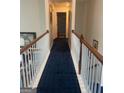 Upstairs hallway with carpet runner, white posts and wooden railing at 233 Mistybrook Cir, Stone Mountain, GA 30087