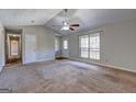 Bright living room with a vaulted ceiling, carpet flooring and a large window at 130 Bradley Pl, Mcdonough, GA 30253
