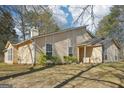 Side view of the home showcasing the siding, windows, and well-maintained lawn at 3396 Framingham Dr, Lithonia, GA 30038