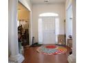 Bright foyer with hardwood floors, white pillars, and a colorful round rug at 185 Ridgewood Dr, Fayetteville, GA 30215