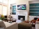 Spacious living room with fireplace, built-in shelves, and abundant natural light at 185 Ridgewood Dr, Fayetteville, GA 30215