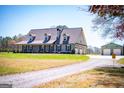 Lovely home with a charming covered porch, a long driveway, and a detached garage at 640 Lovell Rd, Temple, GA 30179