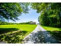 Sprawling property featuring a large lawn, long driveway, and a detached garage at 640 Lovell Rd, Temple, GA 30179