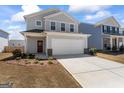 Charming two-story home features a two-car garage and a well-maintained front yard with fresh landscaping at 813 Royal Red Ct, Mcdonough, GA 30253
