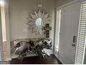 Inviting entryway featuring a unique accent table, sunburst mirror, and natural light at 329 Harris Ave, Locust Grove, GA 30248