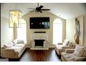 Bright living room with vaulted ceilings, a cozy fireplace, and stylish decor at 329 Harris Ave, Locust Grove, GA 30248