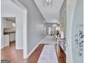 Open foyer with hardwood flooring, a view into the living room, and a glimpse of the kitchen at 147 Kripple Kreek Dr, Sharpsburg, GA 30277