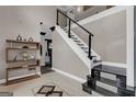 Open foyer featuring an elegant staircase and custom shelving, creating a welcoming space and architectural interest at 3144 Sherwood Oaks Ln, Decatur, GA 30034