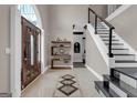 Inviting foyer featuring a decorative tiled floor, an elegant staircase, and custom shelving, creating a warm entrance at 3144 Sherwood Oaks Ln, Decatur, GA 30034