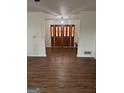 Inviting entryway with striking stained glass double doors and wood flooring at 2791 Biscayne Dr, Conyers, GA 30012