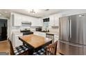 Bright kitchen with white cabinets, stainless steel appliances, and central island at 100 Williams Blf, Mcdonough, GA 30252