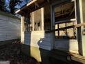 View of broken glass on an enclosed front porch at 65 Little John Trl, Hampton, GA 30228