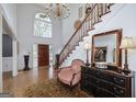 Grand foyer with a soaring ceiling, chandelier, staircase, and a large window providing ample natural light at 3320 Lost Valley Dr, Jonesboro, GA 30236