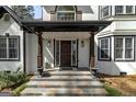 Inviting front porch featuring stone steps, elegant columns, and decorative planters enhancing the home's curb appeal at 3320 Lost Valley Dr, Jonesboro, GA 30236