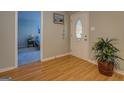 Bright foyer with hardwood floors, a decorative front door, and a view into an adjacent bedroom at 106 Kirkland Rd, Covington, GA 30016