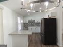 Bright kitchen featuring a breakfast bar, stainless steel appliances, white cabinets, and modern lighting at 851 Bridgewater Ct, Stone Mountain, GA 30088