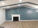 Spacious living room with a white mantle fireplace and wooden beam ceiling at 851 Bridgewater Ct, Stone Mountain, GA 30088