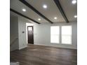 Open living room features wood flooring, recessed lighting and a wooden beamed ceiling at 851 Bridgewater Ct, Stone Mountain, GA 30088