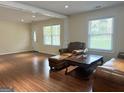 Comfortable living room boasts gleaming hardwood floors and an abundance of natural light at 6544 Bussell Way, Riverdale, GA 30274