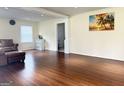 Bright living room with gleaming hardwood floors, natural light, and neutral color palette at 6544 Bussell Way, Riverdale, GA 30274