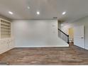 Spacious living room with built-in shelving and wood-look flooring at 461 Best Friends Turn Aly, Mcdonough, GA 30252